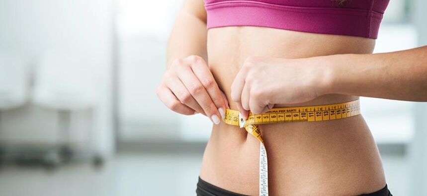Girl measuring waist size