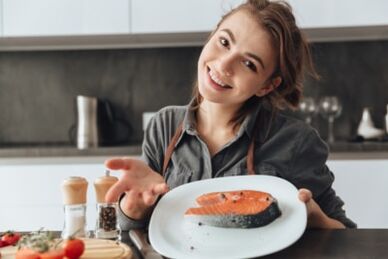 Young girl with salmon steak